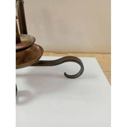 11 - A antique handheld candle stick designed to swivel when walking upstairs