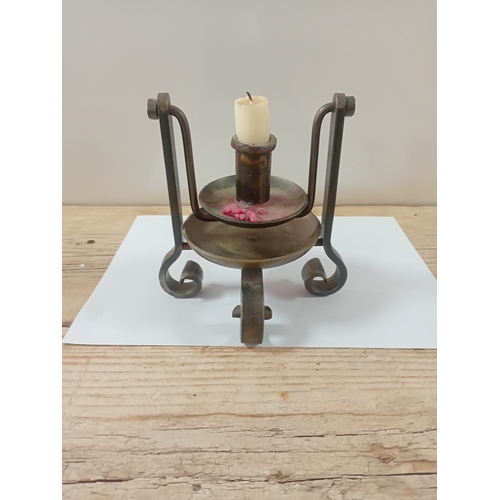11 - A antique handheld candle stick designed to swivel when walking upstairs