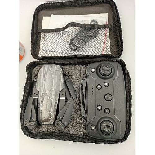 48 - A unused E99 compact drone with carry case and accessories.