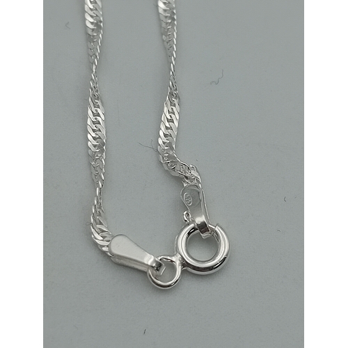 395 - A number 16 pendant on a stamped 925 silver necklace.