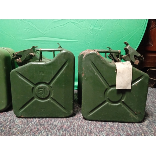 26 - A collection of vintage metal Jerry cans. To include 4 5 litre cans & 1 10 litre can.