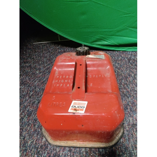 75 - A vintage red metal 5 litre jerrycan, a vintage metal oil can.