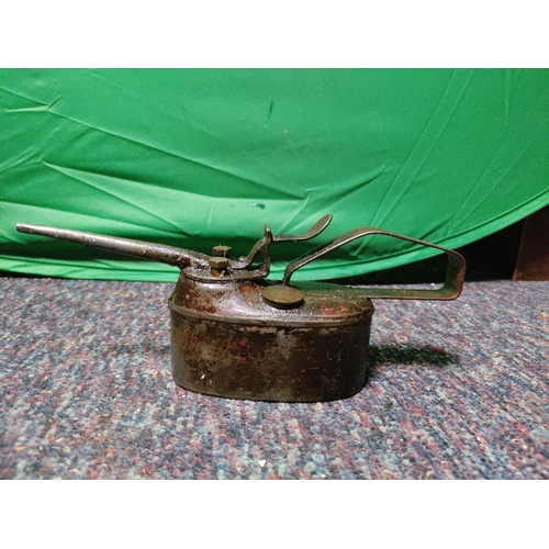 75 - A vintage red metal 5 litre jerrycan, a vintage metal oil can.