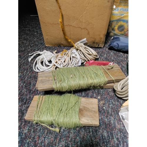 80 - A collection of garden items. To include false stones, string, plant food, bird feeder, pruners, was... 