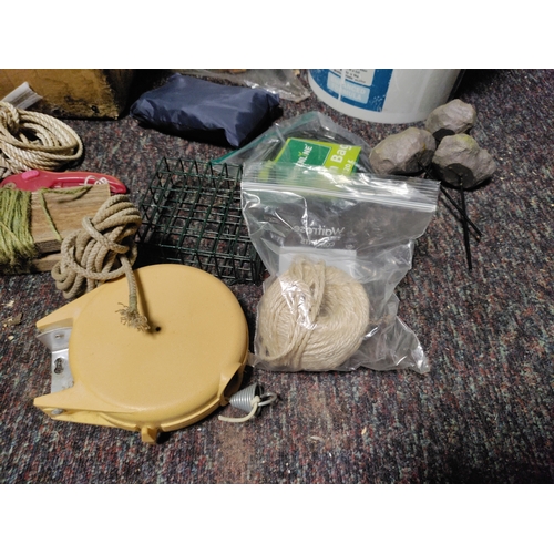 80 - A collection of garden items. To include false stones, string, plant food, bird feeder, pruners, was... 