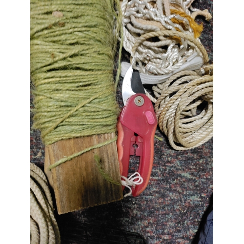 80 - A collection of garden items. To include false stones, string, plant food, bird feeder, pruners, was... 