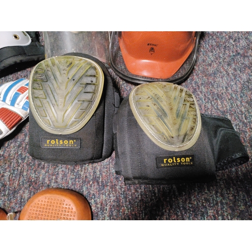 116 - A collection of protective equipment. To include black spur knee pads, Stihl safety helmet, rolson k... 