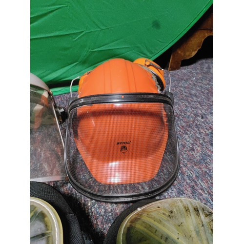 116 - A collection of protective equipment. To include black spur knee pads, Stihl safety helmet, rolson k... 