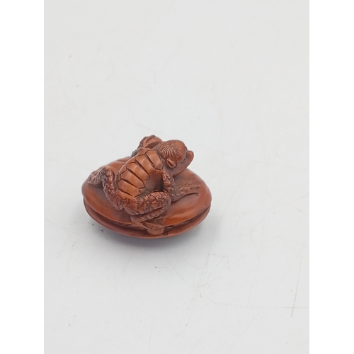 A Japanese netsuke Frog on a clamshell.