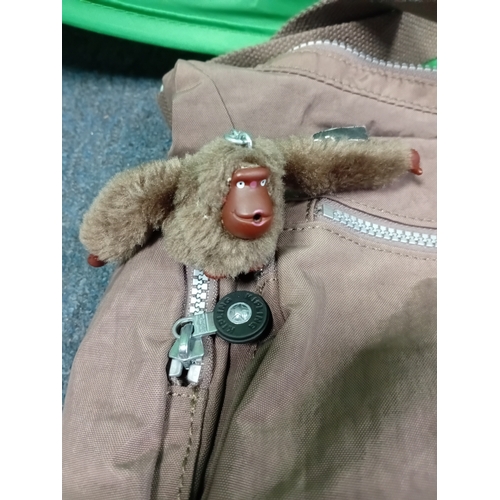 269 - A Brown Kipling crossbody handbag with monkey charm.