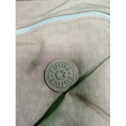 269 - A Brown Kipling crossbody handbag with monkey charm.