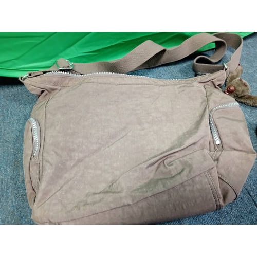 269 - A Brown Kipling crossbody handbag with monkey charm.