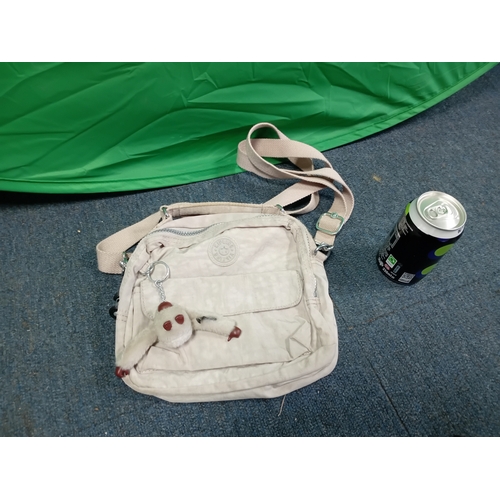 271 - A cream Kipling crossbody handbag with monkey. Some stains as shown in photos.