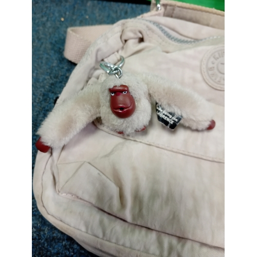 271 - A cream Kipling crossbody handbag with monkey. Some stains as shown in photos.