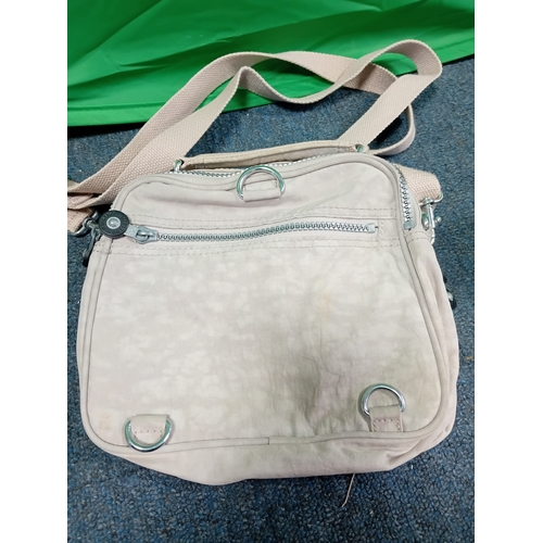 271 - A cream Kipling crossbody handbag with monkey. Some stains as shown in photos.