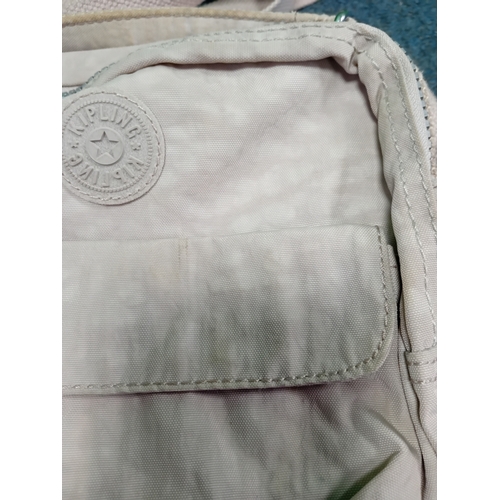 271 - A cream Kipling crossbody handbag with monkey. Some stains as shown in photos.