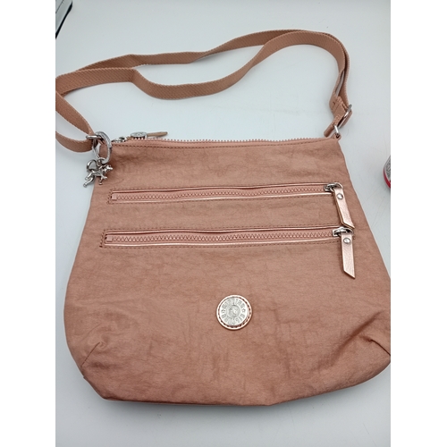 281 - A Kipling crossbody handbag in a champagne colour.