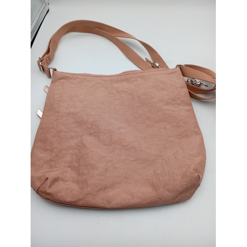 281 - A Kipling crossbody handbag in a champagne colour.