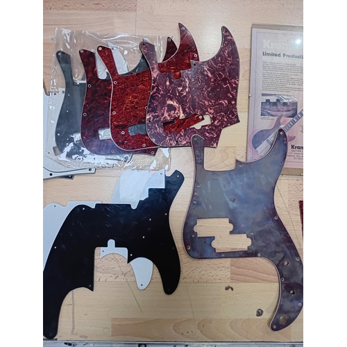 143 - A collection of vintage guitar stratch plates, strings, precision bass bridge, pickup covers and mor... 