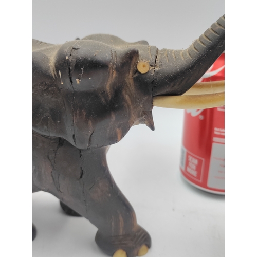 31 - A trio of carved ebony and bone elephant figurines. Some damage as shown in pictures.