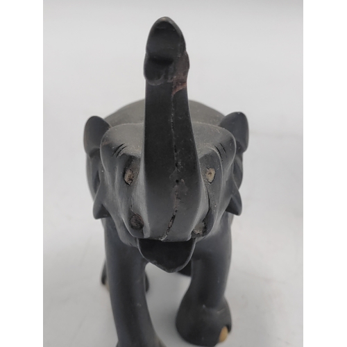 31 - A trio of carved ebony and bone elephant figurines. Some damage as shown in pictures.