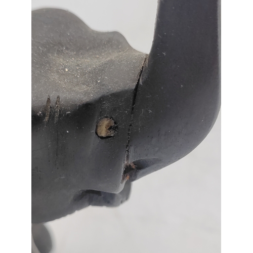 31 - A trio of carved ebony and bone elephant figurines. Some damage as shown in pictures.