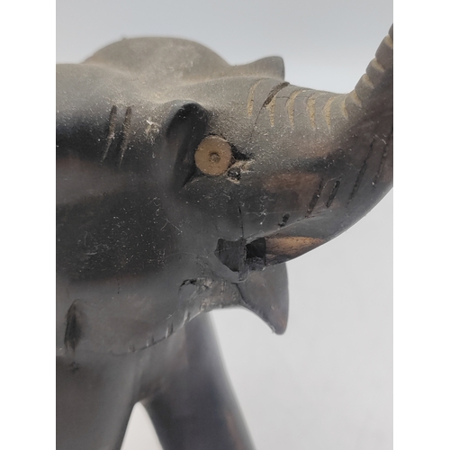 31 - A trio of carved ebony and bone elephant figurines. Some damage as shown in pictures.