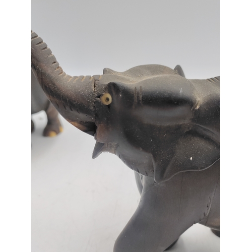31 - A trio of carved ebony and bone elephant figurines. Some damage as shown in pictures.
