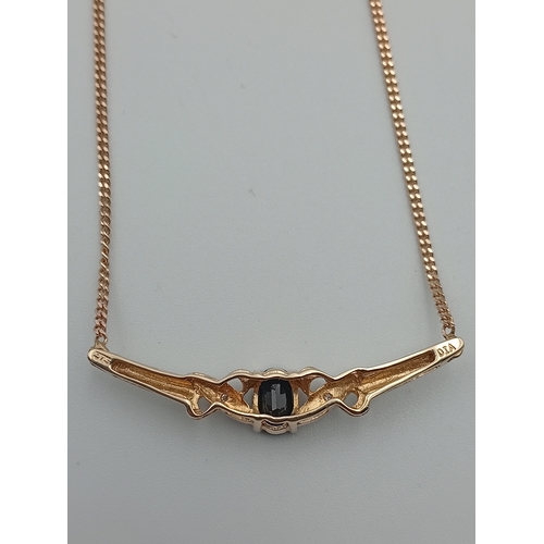 385 - A stamped 375 9ct gold pendant necklace set with a sapphire and diamonds. Length 17.5 inches.