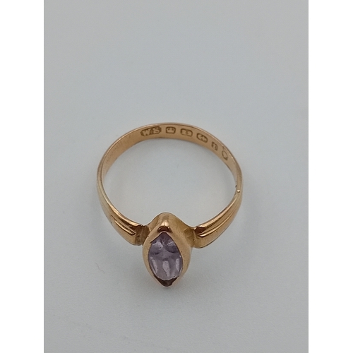 399 - An antique hallmarked Birmingham 22ct gold ring set with a lilac colour stone. Size O