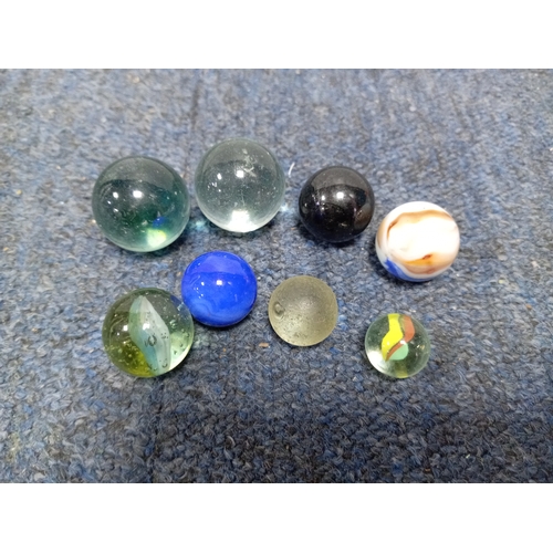 155 - A collection of vintage marbles in various colours and sizes.