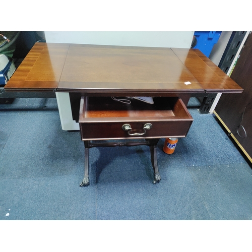 137 - A mahogany drop-leaf table with claw feet on castors.