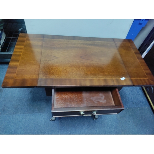 137 - A mahogany drop-leaf table with claw feet on castors.