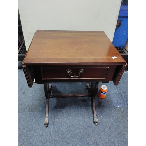 137 - A mahogany drop-leaf table with claw feet on castors.