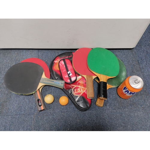 162 - A collection of table tennis paddles, two balls and a Dunlop paddle case.