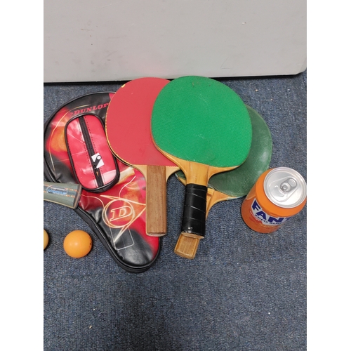 162 - A collection of table tennis paddles, two balls and a Dunlop paddle case.