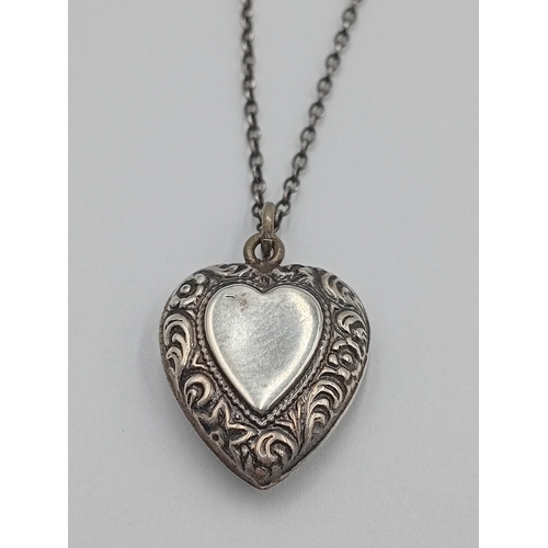 361 - A vintage stamped silver heart pendant on a white metal chain.