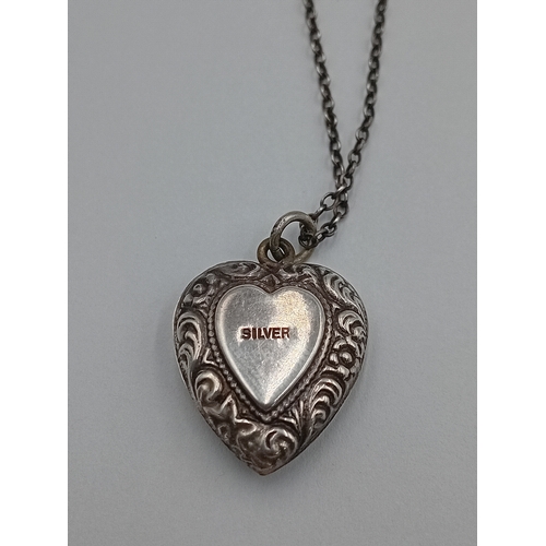361 - A vintage stamped silver heart pendant on a white metal chain.