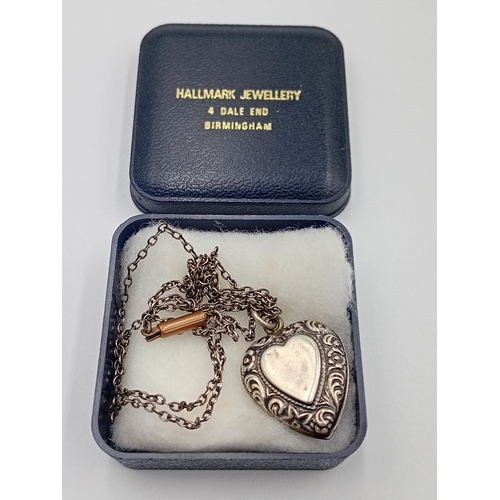 361 - A vintage stamped silver heart pendant on a white metal chain.