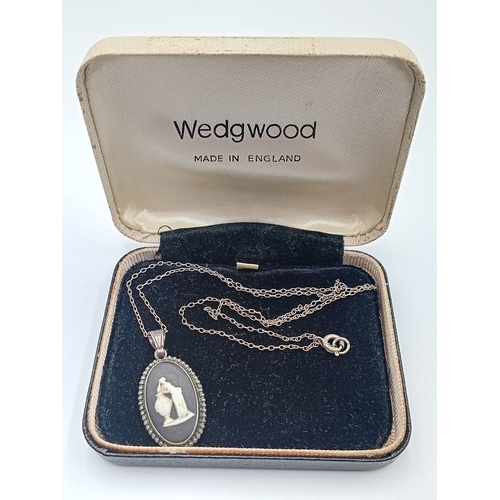 362 - A vintage wedgewood black jasperware pendant with a stamped Sterling Silver chain.