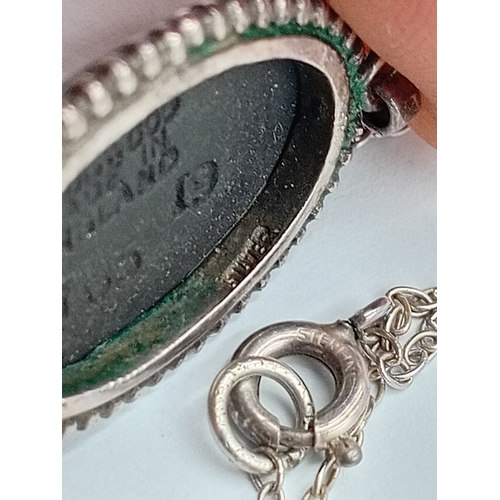 362 - A vintage wedgewood black jasperware pendant with a stamped Sterling Silver chain.