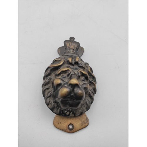 230 - A pair of Victorian door knockers. One a lions head brass door knocker & an equestrian hunt themed d... 
