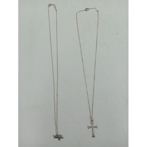365 - Two silver necklaces. One has a stamped 925 elephant pendant and the other has a stamped 925 crucifi... 
