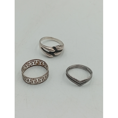 367 - A collection of 3 silver rings. To include a dolphin ring, greek key design ring and a chevron ring.