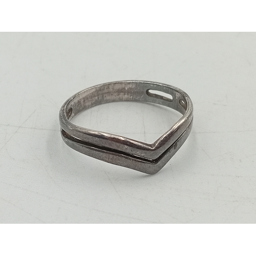 367 - A collection of 3 silver rings. To include a dolphin ring, greek key design ring and a chevron ring.