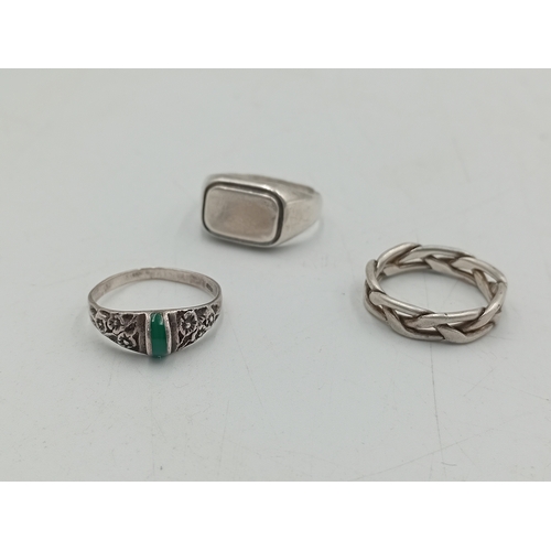368 - A collection of 3 stamped 925 silver rings. One has a floral design with a green stone, one is a cha... 