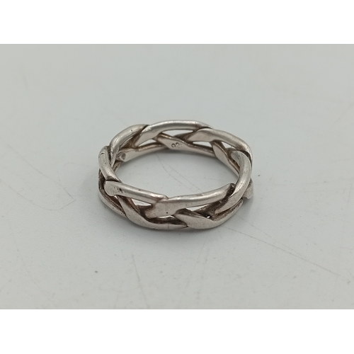 368 - A collection of 3 stamped 925 silver rings. One has a floral design with a green stone, one is a cha... 