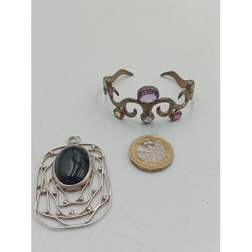 369 - A vintage stamped 925 silver bangle set with colourful stones and a hallmarked silver pendant with a... 