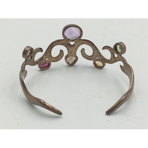 369 - A vintage stamped 925 silver bangle set with colourful stones and a hallmarked silver pendant with a... 