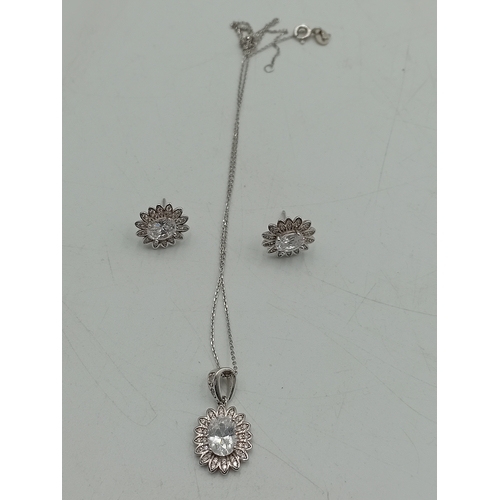372 - A stamped 925 silver necklace and earring set. Chain is tangled.
